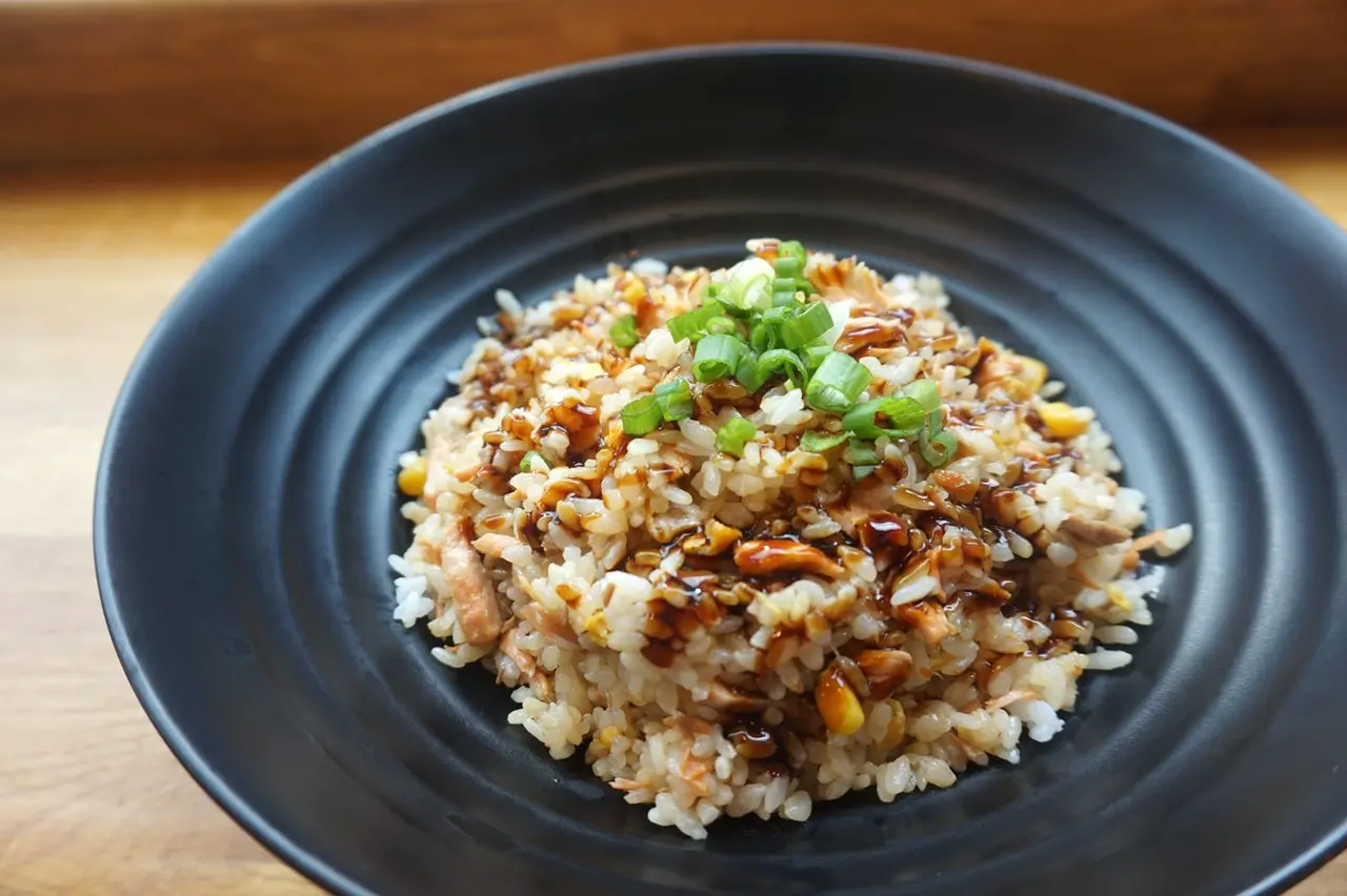 Plate of fried rice topped with soy sauce and green onions Plate of fried rice topped with soy sauce and green onions